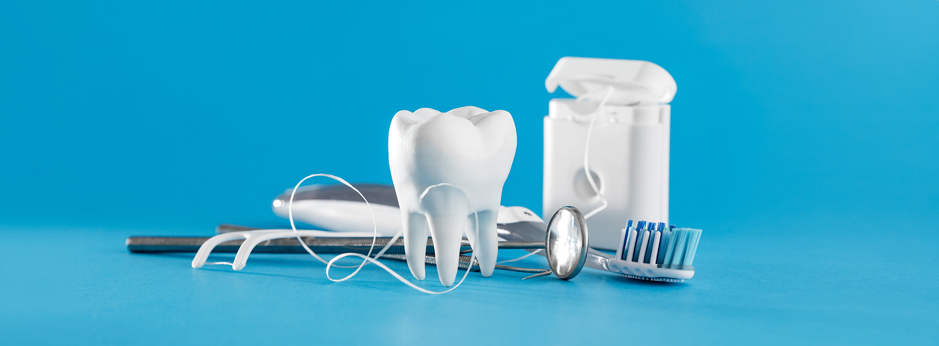 This is a composite image showing medical equipment and supplies, including a stethoscope, blood pressure cuff, tongue depressors, and other instruments, arranged in a manner that suggests they are part of a medical examination or procedure. The background is a solid color to emphasize the items.